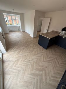 Herringbone pattern LVT flooring fitted in a new build property by Koti Homes